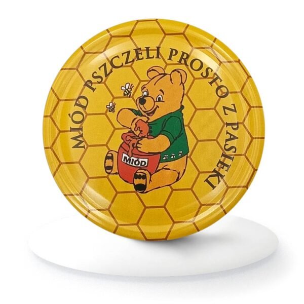 Zakrętka do słoika z miodem z ilustracją misia i napisem "Miód pszczeli prosto z pasieki"